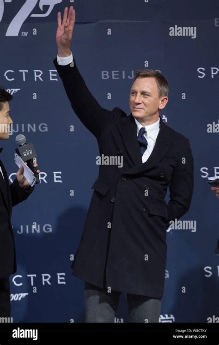 Actor Daniel Craig waves during the filming of a James Bond movie at Palio horse race in Siena's main square in this August 16, 2007 file photo. The next James Bond movie will be delayed indefinitely due to uncertainty from the still unfinished auction of MGM, the movie studio behind the film series, producers said on April 19, 2010. Picture taken August 16, 2007. REUTERS/Marco Bucco/Files (ITALY - Tags: SOCIETY ENTERTAINMENT)