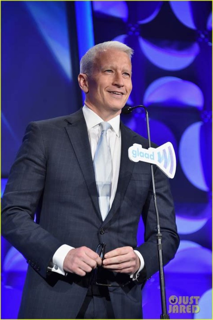 Anderson Cooper accepting GLAAD awards from Madonna