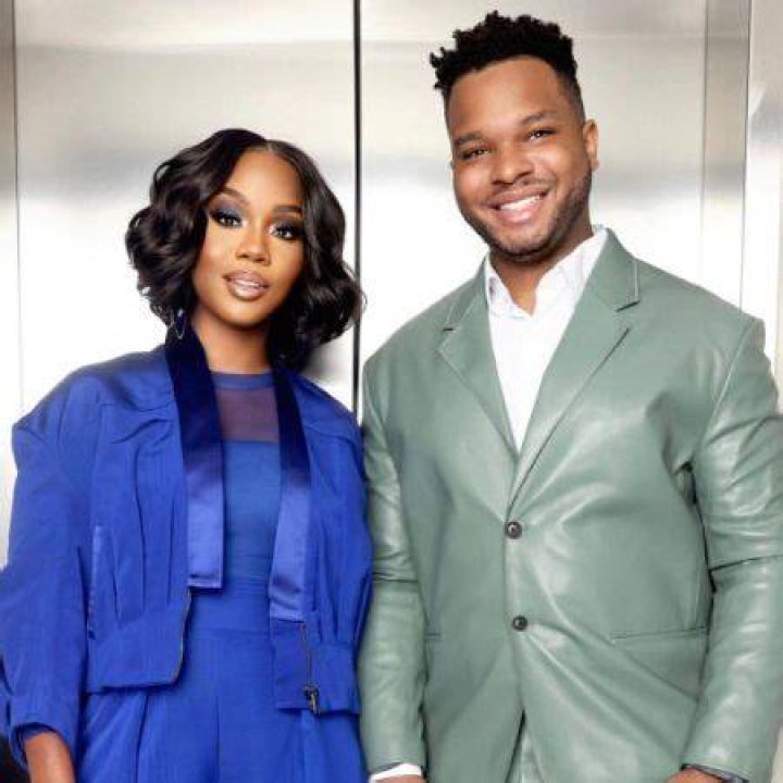 Malachi Jakes and Sarah Jakes Roberts are touching their heads while taking a selfie.