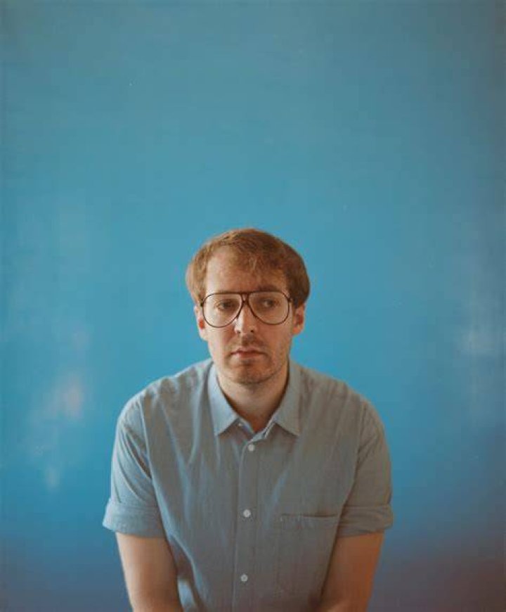 Olli Haaskivi posing in a light blue shirt.
