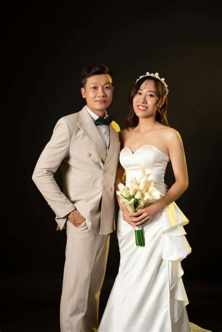 The couple are wearing a black and dark-silver coat .